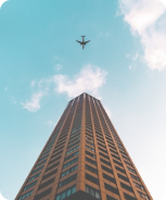 skyscraper with aeroplane at the background